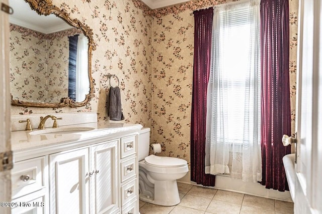 bathroom featuring tile patterned floors, toilet, healthy amount of natural light, crown molding, and wallpapered walls