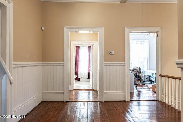 foyer entrance featuring hardwood / wood-style flooring and a wainscoted wall