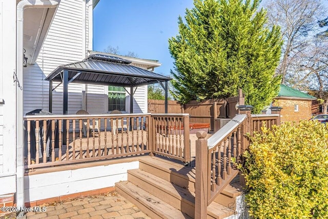 wooden terrace featuring a gazebo