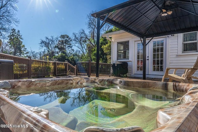 view of swimming pool featuring a deck, a gazebo, a grill, french doors, and a pool