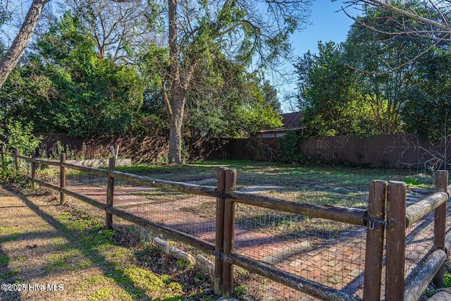 fenced backyard featuring a gate