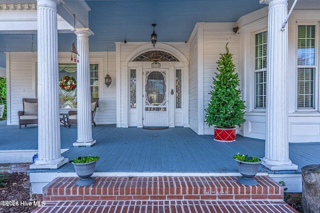 view of exterior entry with a porch