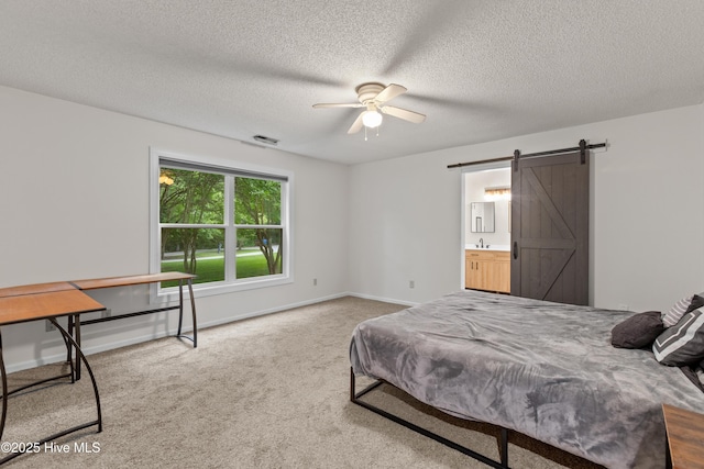 510 Greenfield Pl, Sneads Ferry, NC 28460 - bedroom with a barn door, carpet floors, a textured ceiling, and baseboards