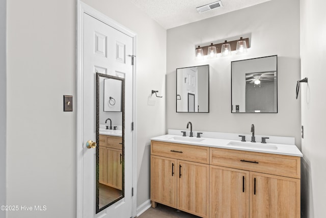 510 Greenfield Pl, Sneads Ferry, NC 28460 - bathroom with double vanity, a textured ceiling, and ceiling fan