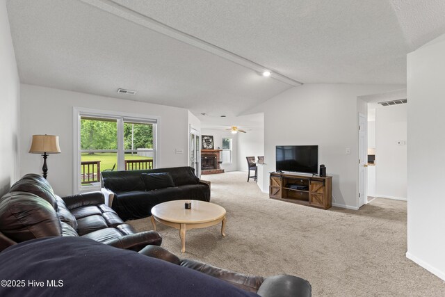510 Greenfield Pl, Sneads Ferry, NC 28460 - carpeted living area featuring a ceiling fan, lofted ceiling, baseboards, and a textured ceiling