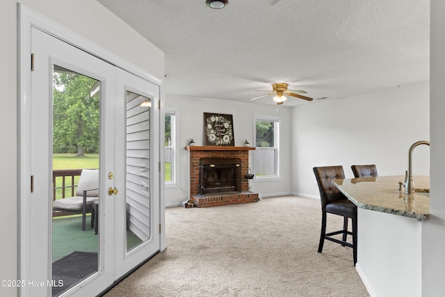 510 Greenfield Pl, Sneads Ferry, NC 28460 - dining area featuring carpet flooring, a textured ceiling, ceiling fan, a fireplace, and baseboards