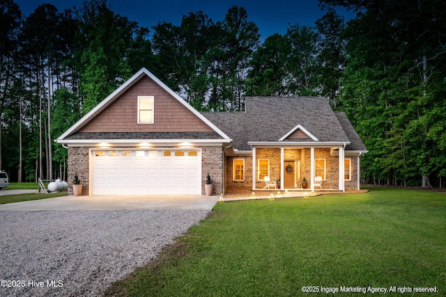 118 Hill Creek Rd, Blounts Creek, NC 27814 - view of front of home with driveway, a front yard, a porch, brick siding, and roof with shingles