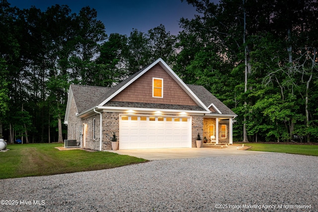 118 Hill Creek Rd, Blounts Creek, NC 27814 - view of front of home with driveway, cooling unit, an attached garage, a front yard, and brick siding