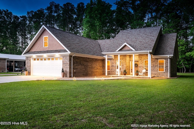 118 Hill Creek Rd, Blounts Creek, NC 27814 - view of front facade with brick siding, concrete driveway, a shingled roof, a front lawn, and covered porch