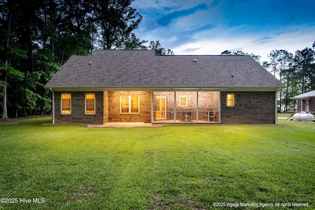 118 Hill Creek Rd, Blounts Creek, NC 27814 - back of house with a patio area, brick siding, a lawn, and roof with shingles