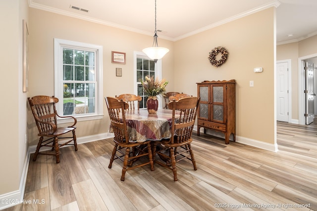 118 Hill Creek Rd, Blounts Creek, NC 27814 - dining area with light wood-type flooring, baseboards, and crown molding
