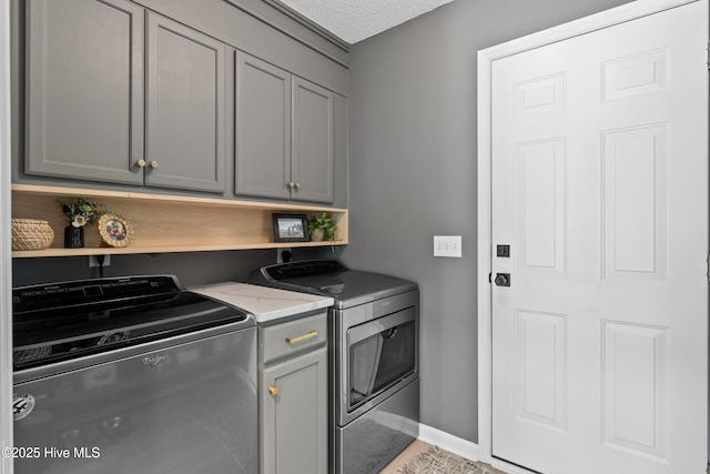 415 Point View Ct, Wilmington, NC 28411 - washroom with washer and dryer, cabinet space, baseboards, and a textured ceiling