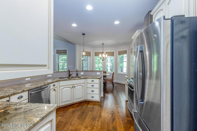 4010 Sienna Trl, New Bern, NC 28562 - kitchen with stainless steel appliances, a sink, a chandelier, dark wood finished floors, and healthy amount of natural light