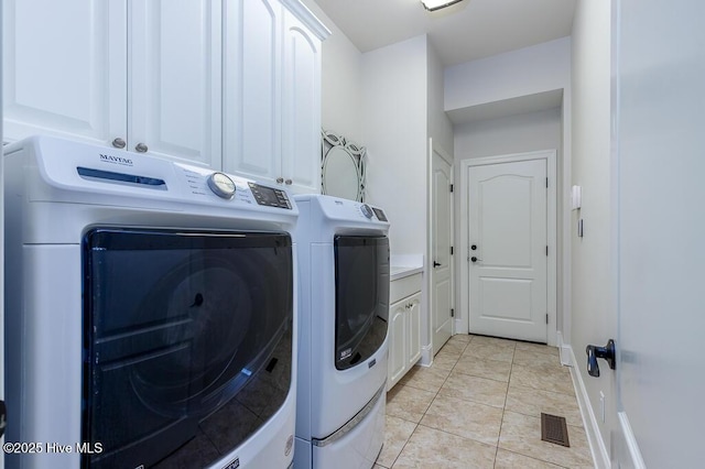4010 Sienna Trl, New Bern, NC 28562 - washroom featuring washing machine and clothes dryer, cabinet space, light tile patterned floors, and baseboards
