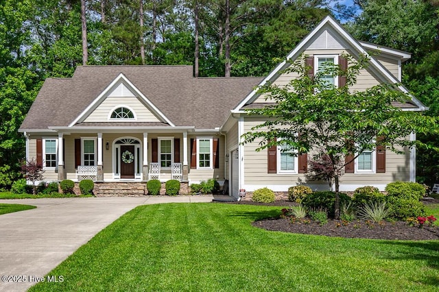 4010 Sienna Trl, New Bern, NC 28562 - view of front of home featuring covered porch, a shingled roof, and a front yard