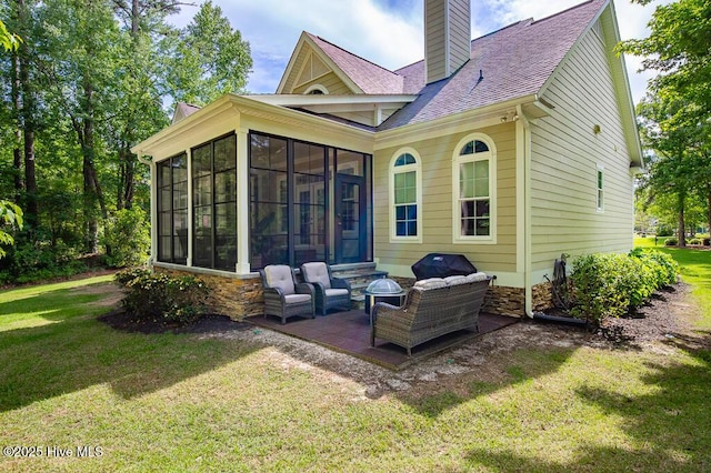 4010 Sienna Trl, New Bern, NC 28562 - back of property with a sunroom, a chimney, roof with shingles, and a lawn