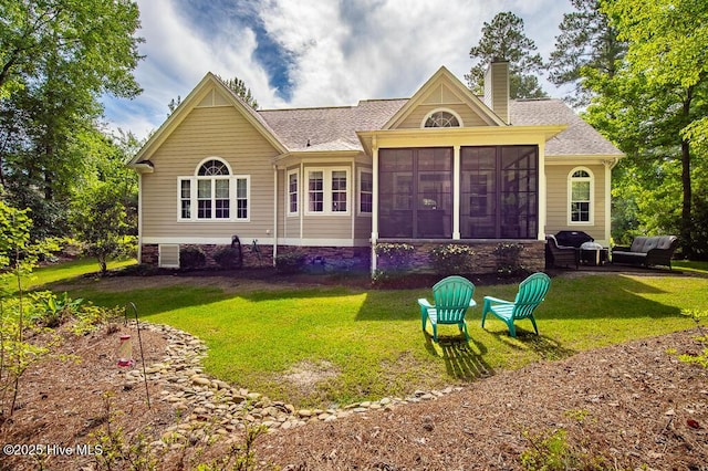 4010 Sienna Trl, New Bern, NC 28562 - back of property featuring a chimney, a sunroom, a yard, and roof with shingles