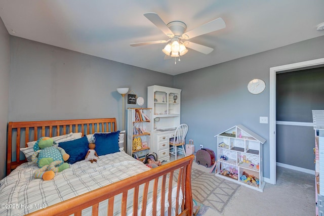 bedroom with carpet floors, a ceiling fan, and baseboards