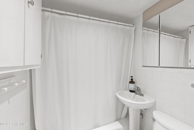 1918 W Fort Macon Rd Unit 205Bogue, Shores Condominium, Atlantic Beach, NC 28512 - full bath with toilet, tile walls, and tasteful backsplash