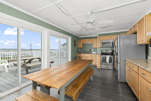 1918 W Fort Macon Rd Unit 205Bogue, Shores Condominium, Atlantic Beach, NC 28512 - kitchen with stainless steel appliances, ceiling fan, dark tile patterned floors, light brown cabinets, and crown molding