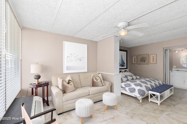 1918 W Fort Macon Rd Unit 205Bogue, Shores Condominium, Atlantic Beach, NC 28512 - bedroom with marble look tiles, a textured ceiling, ensuite bathroom, and a ceiling fan