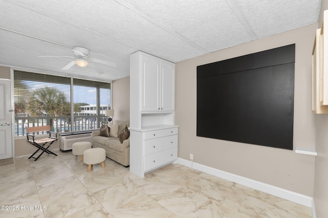 1918 W Fort Macon Rd Unit 205Bogue, Shores Condominium, Atlantic Beach, NC 28512 - sitting room with a ceiling fan, light marble finish flooring, baseboards, and a textured ceiling