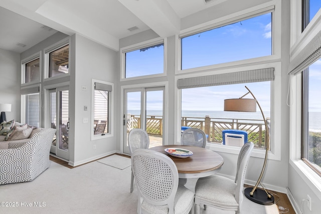 301 Salter Path Rd Unit 72Genesis, Pine Knoll Shores, NC 28512 - dining area with a water view, a high ceiling, and baseboards