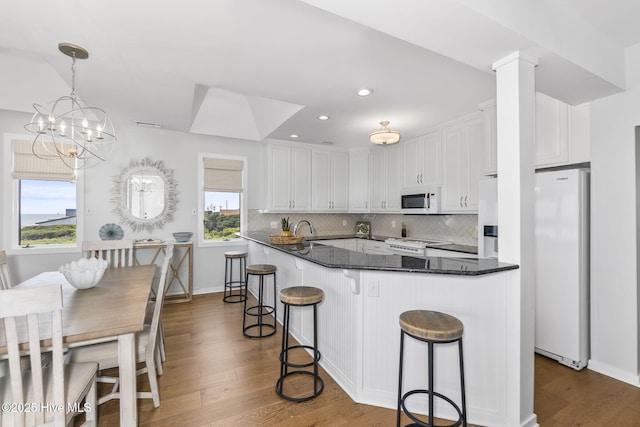 301 Salter Path Rd Unit 72Genesis, Pine Knoll Shores, NC 28512 - kitchen featuring white appliances, white cabinets, dark wood-style floors, tasteful backsplash, and recessed lighting