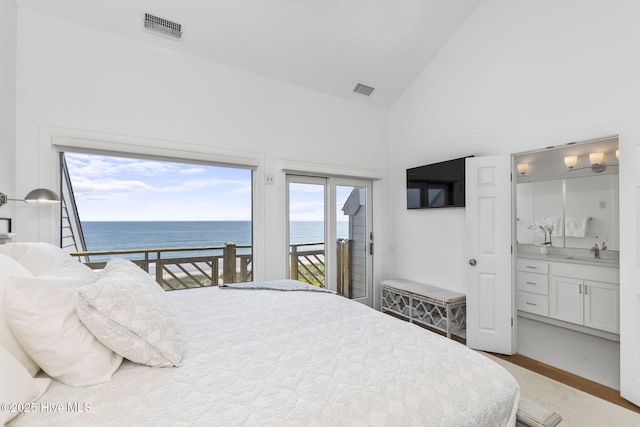301 Salter Path Rd Unit 72Genesis, Pine Knoll Shores, NC 28512 - bedroom featuring access to exterior, high vaulted ceiling, ensuite bathroom, and a sink