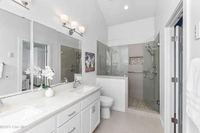 301 Salter Path Rd Unit 72Genesis, Pine Knoll Shores, NC 28512 - bathroom featuring a tile shower, double vanity, toilet, and tile patterned floors