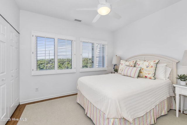 301 Salter Path Rd Unit 72Genesis, Pine Knoll Shores, NC 28512 - bedroom with a closet, ceiling fan, baseboards, and light wood-type flooring