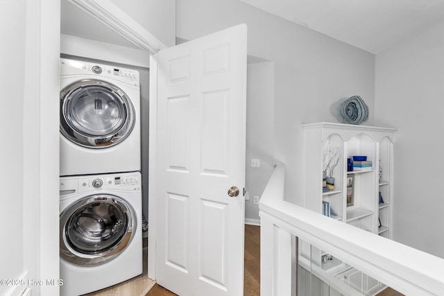 301 Salter Path Rd Unit 72Genesis, Pine Knoll Shores, NC 28512 - washroom featuring stacked washer / dryer and wood finished floors
