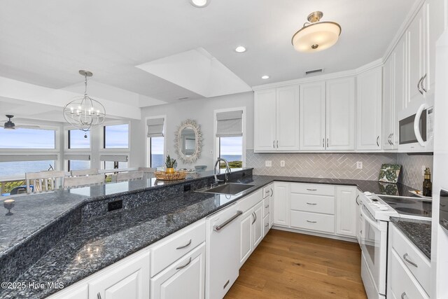 301 Salter Path Rd Unit 72Genesis, Pine Knoll Shores, NC 28512 - kitchen featuring white appliances, a sink, white cabinetry, recessed lighting, and tasteful backsplash
