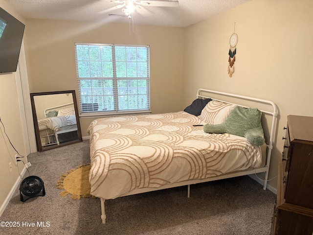 bedroom with carpet flooring, baseboards, a textured ceiling, and a ceiling fan