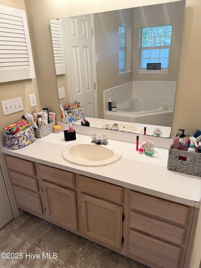 full bath with vanity and a garden tub