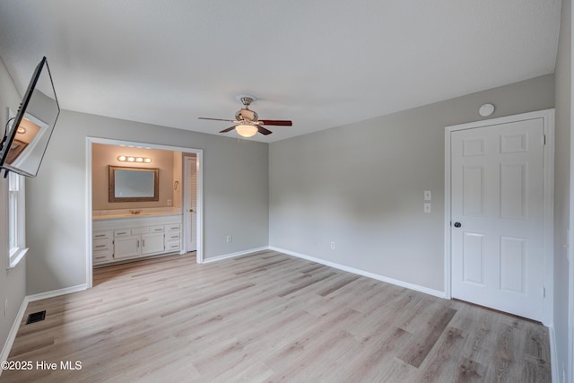 4941 Marlin Ct, Wilmington, NC 28403 - unfurnished bedroom featuring light wood-style floors, baseboards, ensuite bath, and a ceiling fan