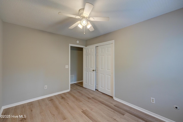 4941 Marlin Ct, Wilmington, NC 28403 - unfurnished bedroom with light wood-style flooring, a closet, baseboards, and a ceiling fan