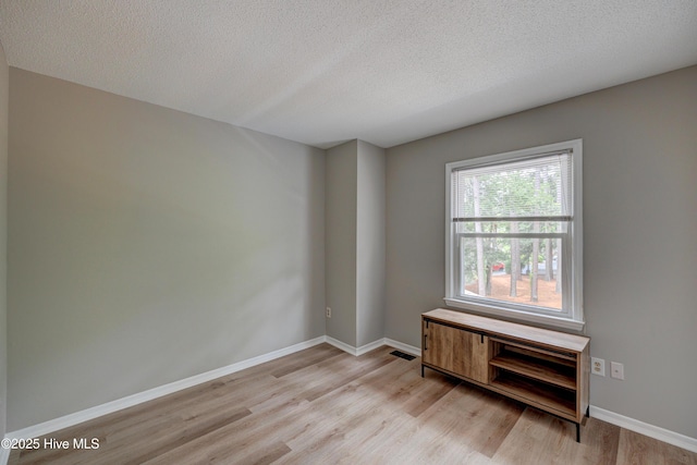 4941 Marlin Ct, Wilmington, NC 28403 - spare room with light wood-type flooring, a textured ceiling, and baseboards