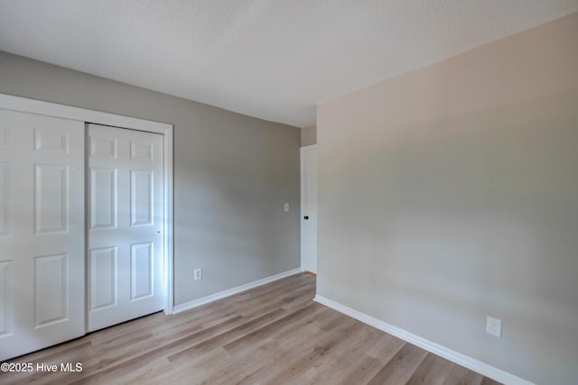 4941 Marlin Ct, Wilmington, NC 28403 - unfurnished bedroom with a closet, light wood-type flooring, and baseboards