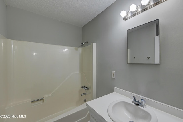 4941 Marlin Ct, Wilmington, NC 28403 - bathroom with tub / shower combination, vanity, and a textured ceiling