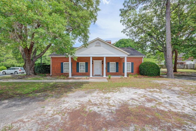 4941 Marlin Ct, Wilmington, NC 28403 - greek revival inspired property with a porch, brick siding, and a chimney