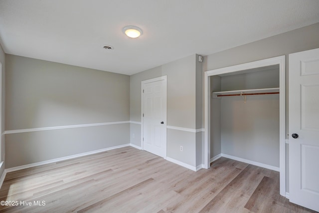 4941 Marlin Ct, Wilmington, NC 28403 - unfurnished bedroom with wood finished floors, a closet, and baseboards