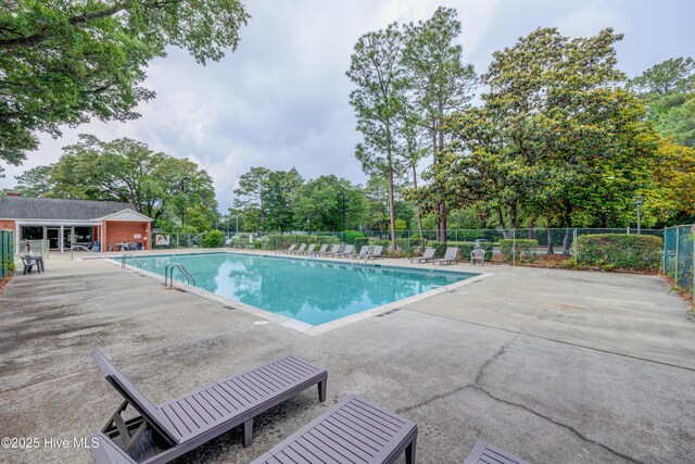 4941 Marlin Ct, Wilmington, NC 28403 - community pool with a patio area and view of scattered trees