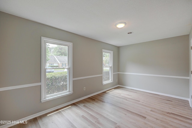 4941 Marlin Ct, Wilmington, NC 28403 - empty room featuring healthy amount of natural light, light wood-type flooring, and baseboards
