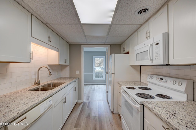 4941 Marlin Ct, Wilmington, NC 28403 - kitchen with white appliances, a sink, light wood finished floors, white cabinets, and decorative backsplash