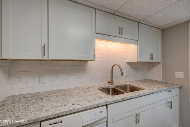 4941 Marlin Ct, Wilmington, NC 28403 - kitchen with a sink, dishwasher, decorative backsplash, a paneled ceiling, and light stone countertops