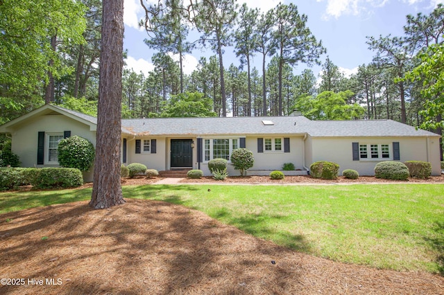 7 Saddle Pl, Pinehurst, NC 28374 - ranch-style home with a front lawn, view of scattered trees, and roof with shingles