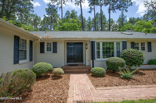 7 Saddle Pl, Pinehurst, NC 28374 - view of exterior entry with brick siding and a shingled roof