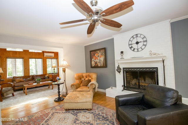 7 Saddle Pl, Pinehurst, NC 28374 - living room featuring wood finished floors, ornamental molding, ceiling fan, and a fireplace