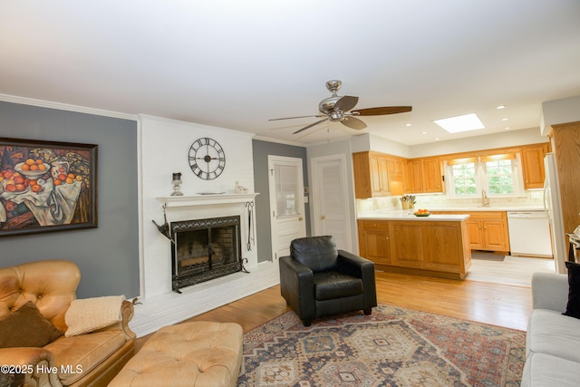 7 Saddle Pl, Pinehurst, NC 28374 - living room with light wood-style floors, a fireplace, ceiling fan, crown molding, and recessed lighting